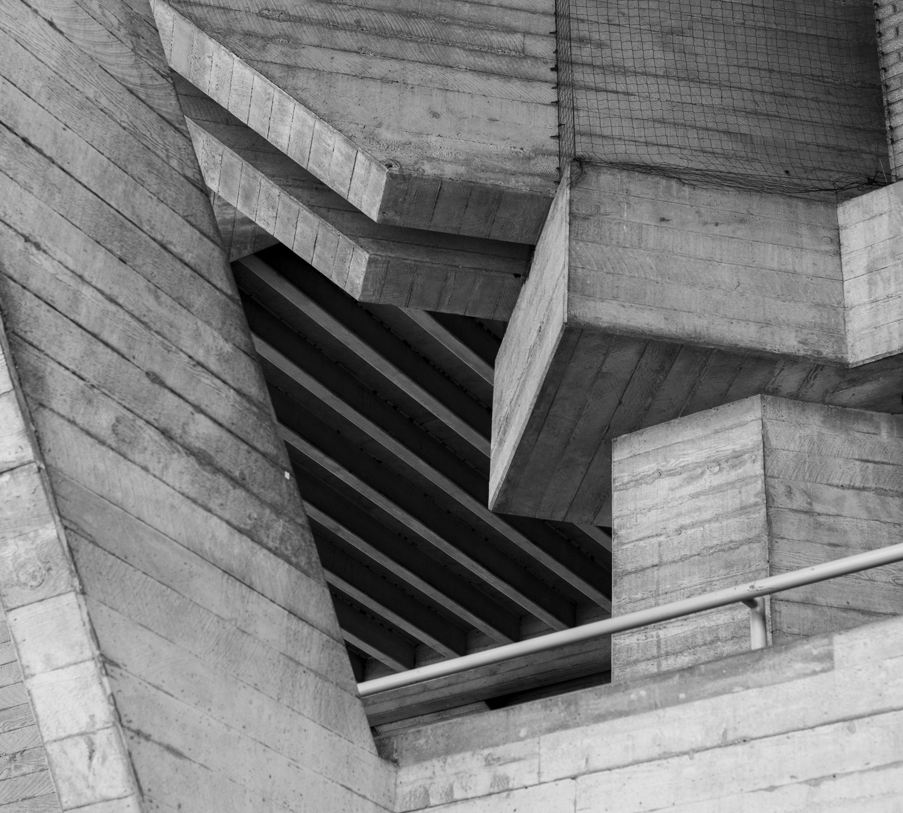 Man Using Measuring Tape in Factory Setting Man Using Measuring Tape in Factory Setting